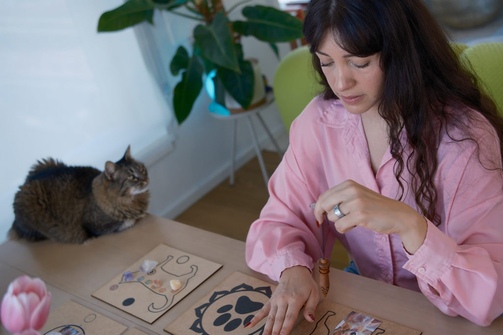 The Constellation: healing table with chakra boards, candles, and a dog photo at the center