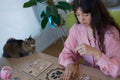 The Constellation: healing table with chakra boards, candles, and a dog photo at the center
